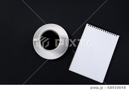 coffee cup and white notepad on black background. top view coffee cup and white notepad on black background. top view 68930648