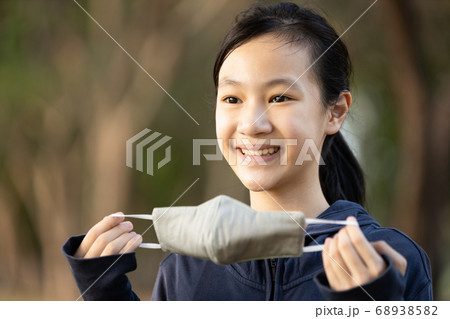 Asian child girl show a mask made of fabric; woman is campaigning to wear a mask before leaving the house to prevent flu; pandemic; contagious or spread of the Coronavirus outbreak; epidemic of Covid- Asian child girl show a mask made of fabric; woman is campaigning to wear a mask before leaving the house to prevent flu; pandemic; contagious or spread of the Coronavirus outbreak; epidemic of Covid- 68938582