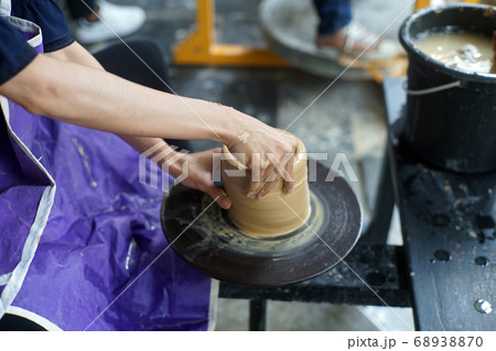 Hand of medieval craftsman female makes a pot 68938870