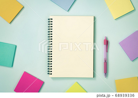 Spiral Notebook and Sticky Note and Pen on Pastel Minimalist Background in Vintage Tone 68939336