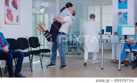 Husband hugging wife after receiving good news Husband hugging wife after receiving good news 68939734
