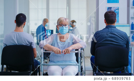 Senior woman with walker in hospital waiting area 68939763