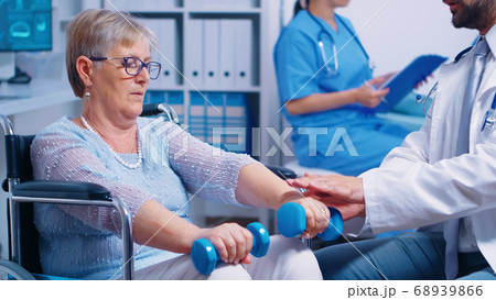 Physiotherapy for elderly woman in wheelchair 68939866