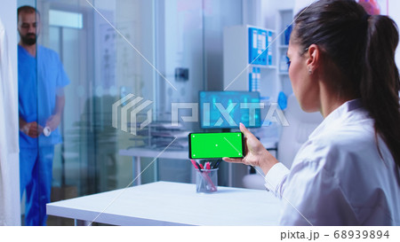 Doctor checking patient results on smartphone Doctor checking patient results on smartphone 68939894