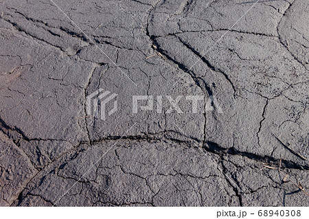 Texture of wet cracked ground as background 68940308