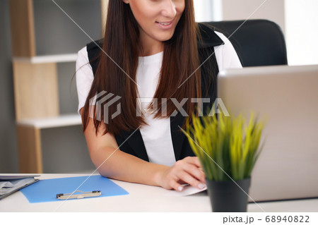 Shot of an attractive young businesswoman working on a laptop at her workplace. 68940822