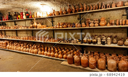 Rustic handmade brown terracotta vases and cups at the pottery shop in Avanos. Ceramic clay souvenirs at handicraft market in Cappadocia, Turkey Rustic handmade brown terracotta vases and cups at the pottery shop in Avanos. Ceramic clay souvenirs at handicraft market in Cappadocia, Turkey 68942419