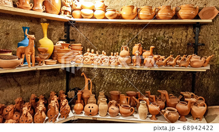 Rustic handmade brown terracotta vases and cups at the pottery shop in Avanos. Ceramic clay souvenirs at handicraft market in Cappadocia, Turkey Rustic handmade brown terracotta vases and cups at the pottery shop in Avanos. Ceramic clay souvenirs at handicraft market in Cappadocia, Turkey 68942422