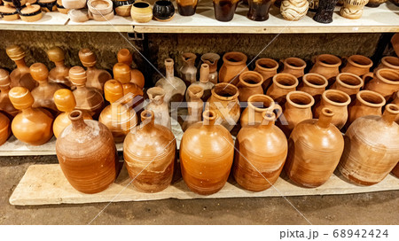Rustic handmade brown terracotta vases and cups at the pottery shop in Avanos. Ceramic clay souvenirs at handicraft market in Cappadocia, Turkey 68942424