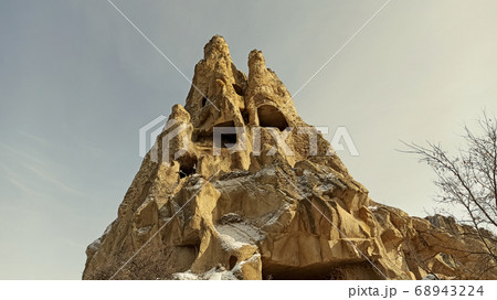 Ancient stone cave houses carved into the volcanic rock in Cappadocia, Turkey Ancient stone cave houses carved into the volcanic rock in Cappadocia, Turkey 68943224