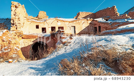 Ancient stone cave houses carved into the volcanic rock in Cappadocia, Turkey 68943230