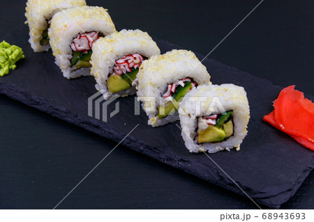 Uramaki sushi rolls with surimi on a black slate 68943693