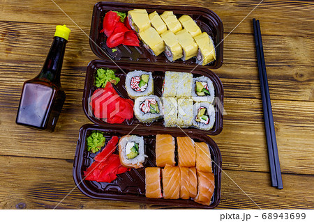 Set of sushi rolls in plastic boxes, soy sauce  68943699