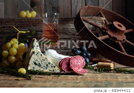 Rustic still life with wine and snacks. Rustic still life with wine and snacks. 68944411