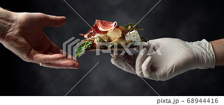 Cracker with blue cheese, prosciutto and pear Cracker with blue cheese, prosciutto and pear 68944416