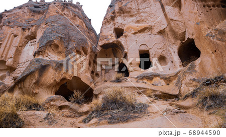 Fairy chimneys and cave houses surrounded by rock formations at Zelve Valley in Cappadocia, Turkey 68944590