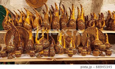 Hittite wine vessels, colorful ceramic vases and porcelain bowls in a underground cave atelier in Avanos in Cappadocia. Turkish traditional ceramic handycrafts in a local pottery shop in Cappadocia 68945345