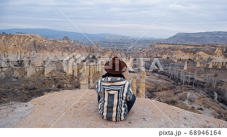 Man watching the volcanic landscape at the valley of love in Goreme, Cappadocia Man watching the volcanic landscape at the valley of love in Goreme, Cappadocia 68946164