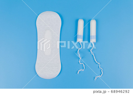 Sanitary pad and tampons on blue background 68946292