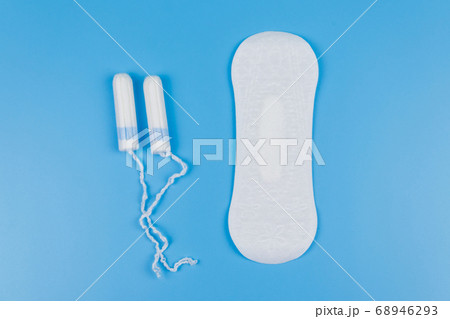 Sanitary pad and tampons on blue background Sanitary pad and tampons on blue background 68946293