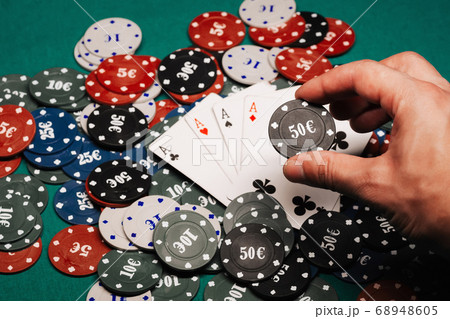 four of a kind of aces on a pile of gaming chips on the green table in the casino close-up four of a kind of aces on a pile of gaming chips on the green table in the casino close-up 68948605