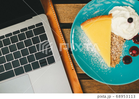 Top view of laptop on the desk with cheesecake in Concept of happy working. 68953113
