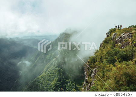 People on steep rocky cliff at Fortaleza Canyon People on steep rocky cliff at Fortaleza Canyon 68954257