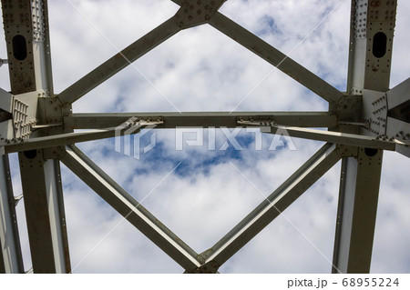 Close-up of an arched farm span of posts and crossbars, rivets on the planes Close-up of an arched farm span of posts and crossbars, rivets on the planes 68955224