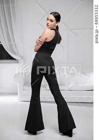 Pretty brunette dressed in a black Pretty brunette dressed in a black 68955332