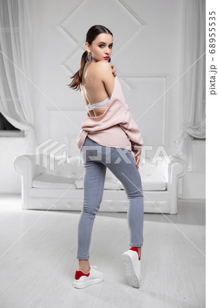 Cute brunette dressed in pink pullover Cute brunette dressed in pink pullover 68955535