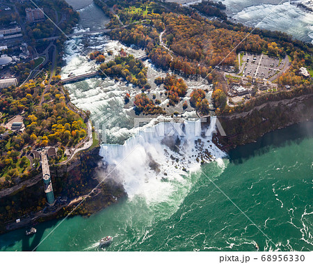 Niagara Falls Aerial View. An aerial view of the American Falls, a part of the Niagara Falls. The falls straddle the border between America and Canada. 68956330