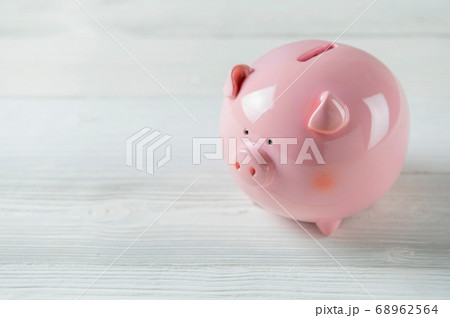 Pink Piggy bank on white wood floor. Financial and Pink Piggy bank on white wood floor. Financial and 68962564