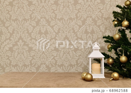 Decorative lantern at the Christmas tree with golden balls, on the velour against the background of delicate wallpaper. Decorative lantern at the Christmas tree with golden balls, on the velour against the background of delicate wallpaper. 68962588