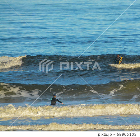 Surfers in the Atlantic, Jacksonville Beach, Duval County, Florida Surfers in the Atlantic, Jacksonville Beach, Duval County, Florida 68965105
