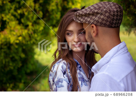 young man hugs his pretty girl when she smiles and young man hugs his pretty girl when she smiles and 68966208
