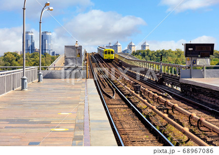 The metro train rushes through the metro bridge The metro train rushes through the metro bridge 68967086