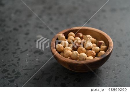 roasted hazelnuts in olive bowl on terrazzo countertop 68969290
