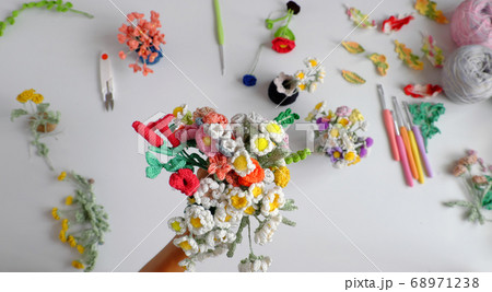 Woman hand hold handmade crochet product, bunch of colorful flower, beautiful artwork diy in leisure activity Woman hand hold handmade crochet product, bunch of colorful flower, beautiful artwork diy in leisure activity 68971238