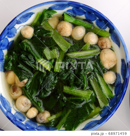Top view spinach and straw mushroom soup bowl for vegan meal 68971459