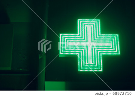Green Cross Sign on a Building of Pharmacy 68972710