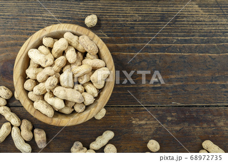 Peanut in a shell texture in a plate. Top view. Peanut in a shell texture in a plate. Top view. 68972735