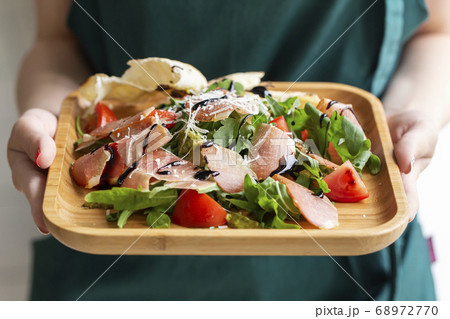 Fresh salad and arugula, bacon, tomatoes sprinkled Fresh salad and arugula, bacon, tomatoes sprinkled 68972770