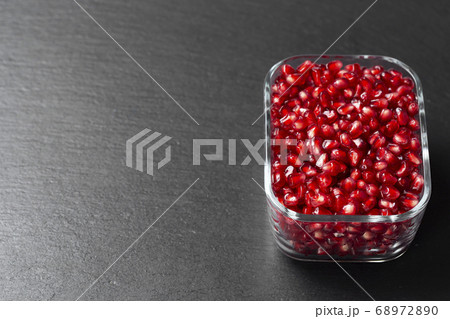 Peeled pomegranate in Minsk on a dark background. Peeled pomegranate in Minsk on a dark background. 68972890