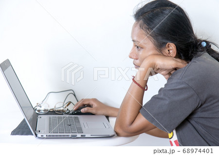 Portrait of Asian woman sitting at a table with Portrait of Asian woman sitting at a table with 68974401