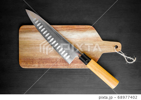 Traditional Japanese gyuto knife on a cutting 68977402