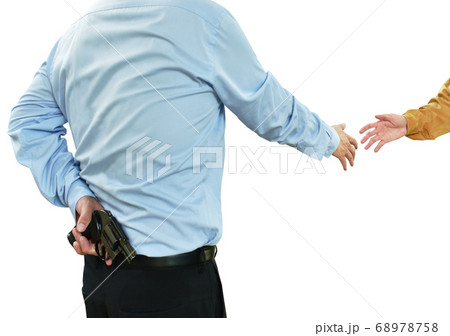 man in blue business shirt hiding gun while shake hand to another people concepts betray and insincere on white background 68978758