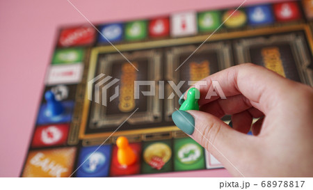 Hand on the background of colorful blurred Board games Hand on the background of colorful blurred Board games 68978817