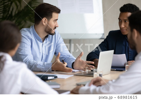 Young diverse mixed race employees sharing ideas at brainstorming meeting. 68981615
