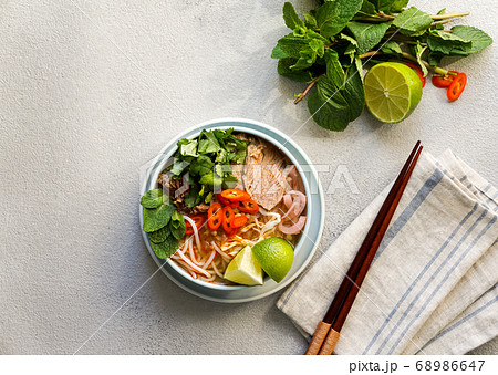 Bun Bo Hue, Bun Bo, Vietnamese beef noodle soup spicy. bowl of beef and rice vermicelli soup, vietnamese noodle cuisine in Hue Bun Bo Hue, Bun Bo, Vietnamese beef noodle soup spicy. bowl of beef and rice vermicelli soup, vietnamese noodle cuisine in Hue 68986647