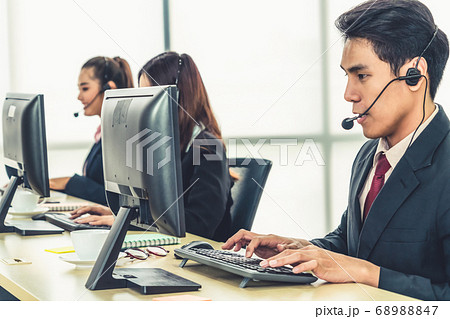 Business people wearing headset working in office Business people wearing headset working in office 68988847
